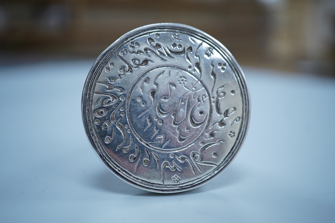 An Islamic white metal seal, of conical form with small ring handle, overall 83mm, 135 grams.